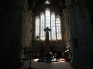 the cross backlit by a church window