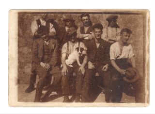 A group of men and a dog.