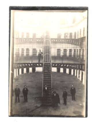 Men standing at the bottom of a stairs.