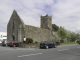 exterior view of the abbey, with cars parked outside