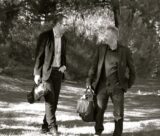 Two male musicians chat while they walk