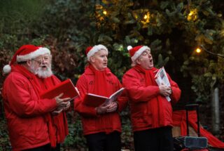 3 singing Santas
