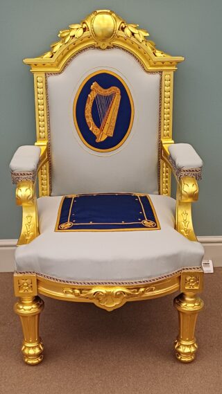 A chair with a harp on it.