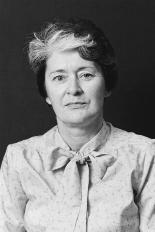 black and white image of a woman looking into the camera