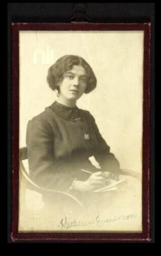 sepia image of a woman sitting down looking at the camera in 20th century dress