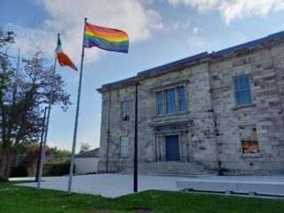 image of Pride and Irish flag flying outside Kilmainham's courthouse building