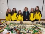 A group of people in front of a lego display