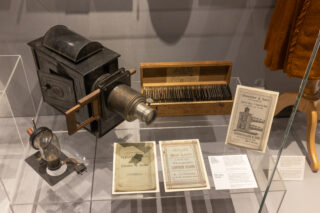 Exhibition Display An old style projector camera in a display cabinet