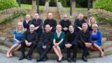 A choir groupof men and ladies.